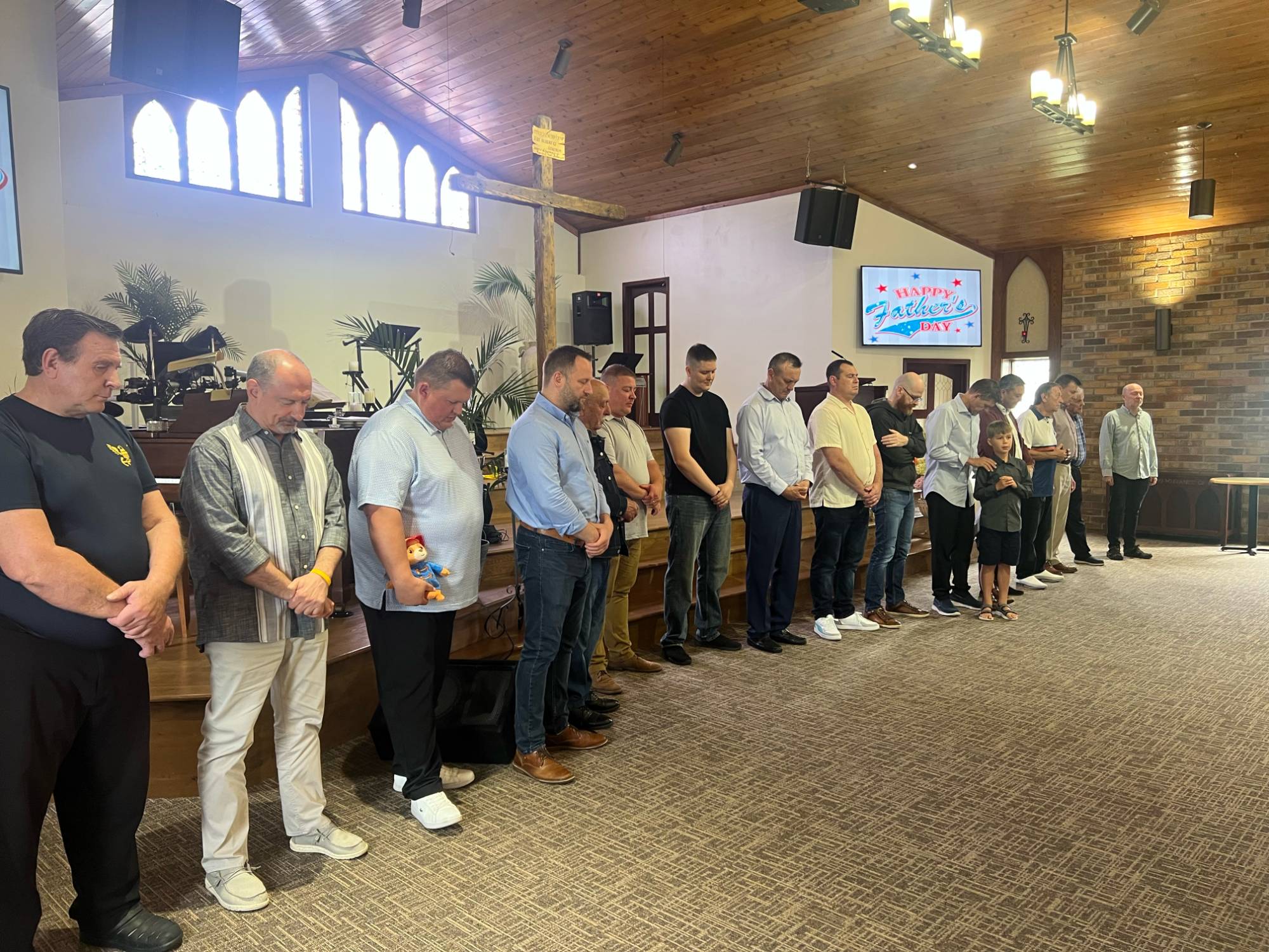Father's Day service — men of the congregation gathered in prayer
